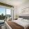 Large well lit bedroom with plush carpets and large windows 