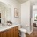 Large well lit bathroom with white accents 