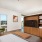 Large well lit bedroom with plush carpets and large windows 