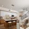 Spacious and well lit kitchen with wood flooring and stainless steel appliances